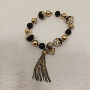 Ann Klien black gold beaded bracelets tassel